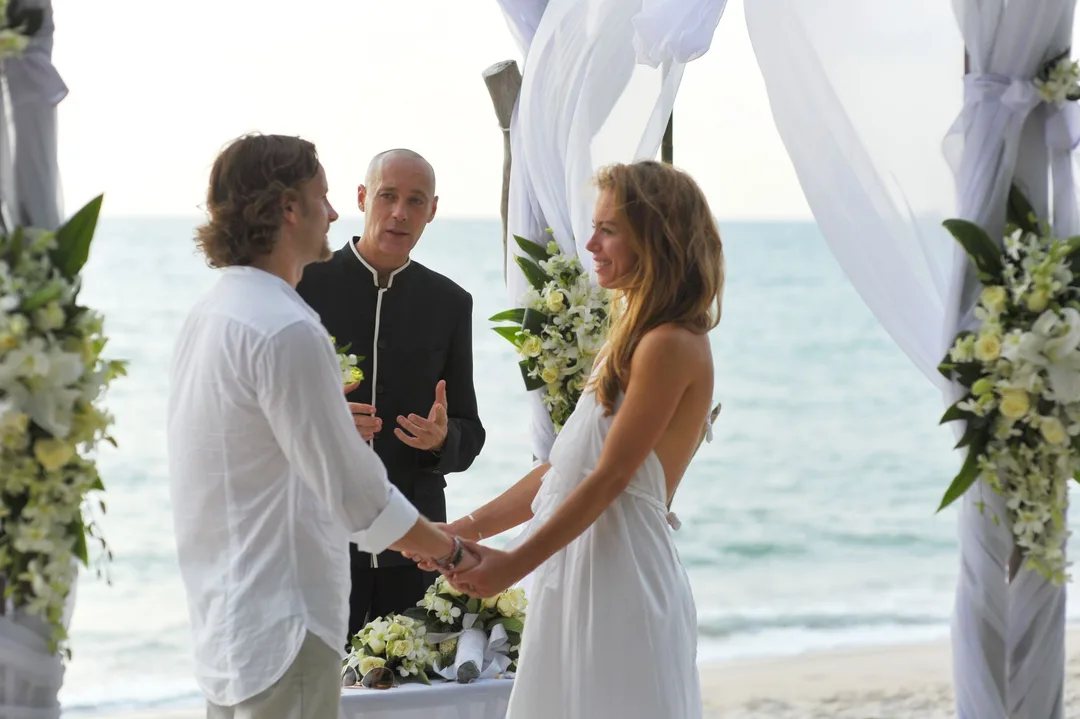 Virtual Celebrant and lovely couple, next to sea, crying bride.